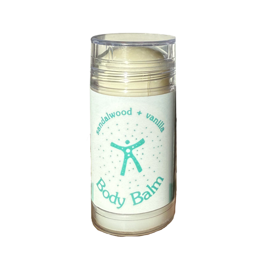 A clear plastic jar of body balm with a white label that reads 'sandalwood + vanilla Body Balm' in teal text, containing a pale cream-colored balm, isolated on a white background.