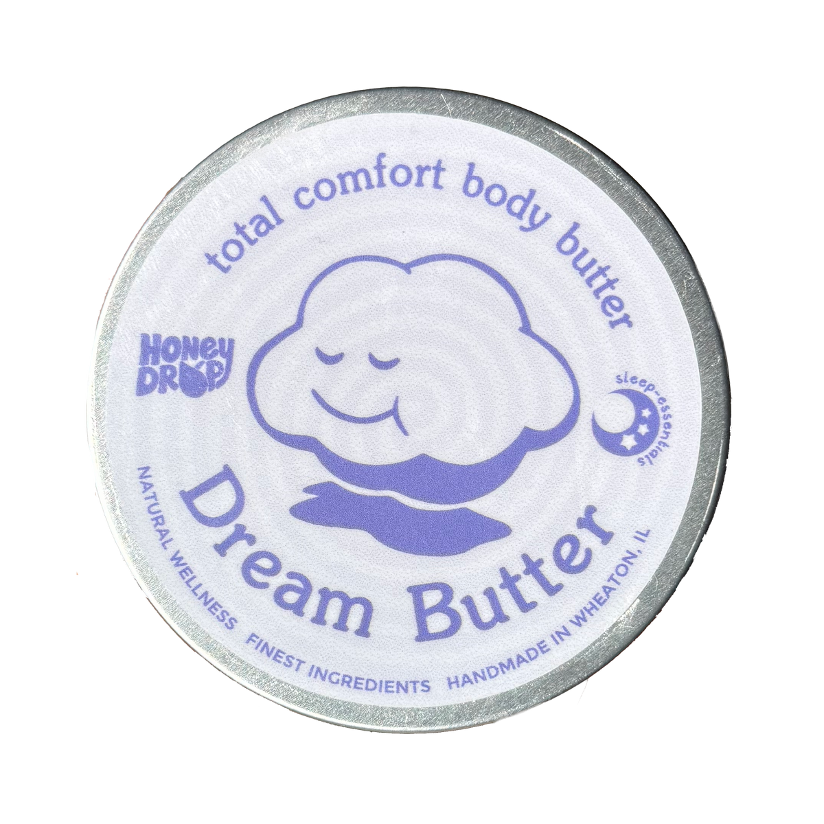 A round tin of Honey Drop Dream Butter body butter with a white lid featuring a purple cartoon cloud and silver metal rim, isolated on a white background.