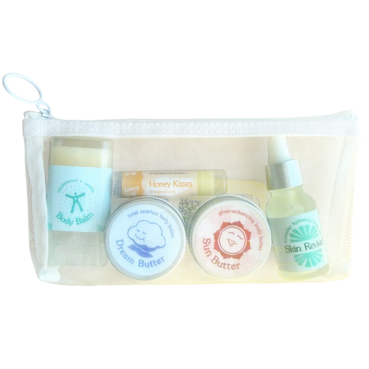 honeydrop mini essentials set is a three piece bodycare set including a lip balm, two mini body butters, mini body balm, and mini body oil in a white pouch