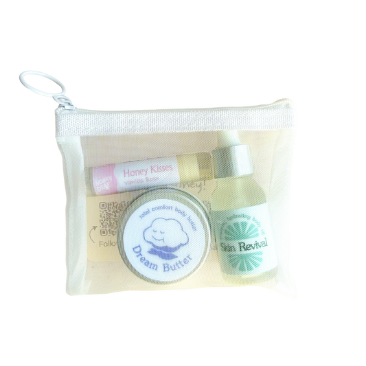 honeydrop mini essentials set is a three piece bodycare set including a lip balm, mini body butter, mini body oil in a white pouch